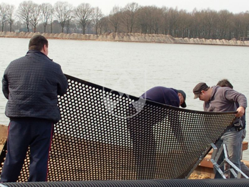 Perforated plastic sheets made of Polystone® G black for the separation of pond zones